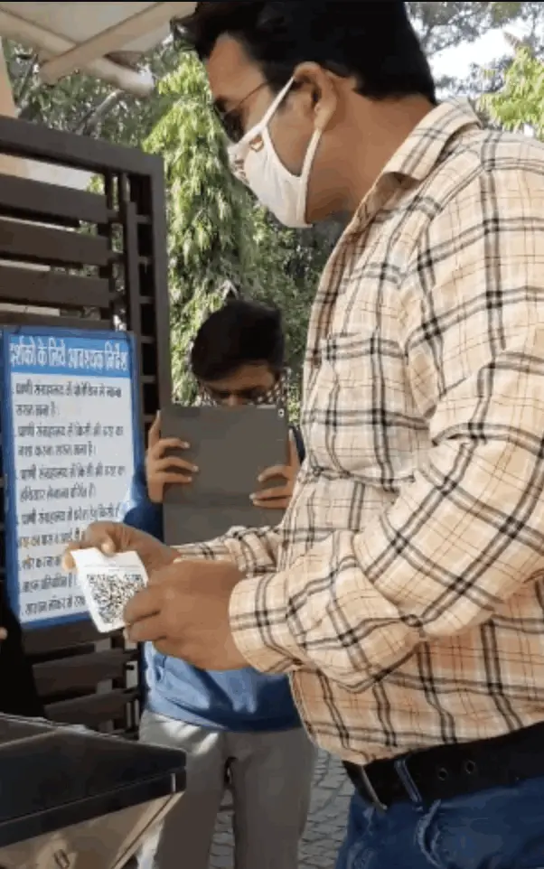 person scanning ticket on touchless entry system